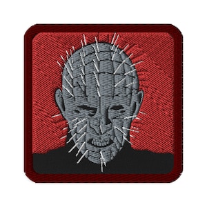 May include: A red embroidered patch with a gray, spiky-headed figure. The figure has a menacing expression and is surrounded by a red border.