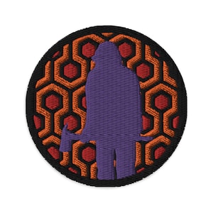 Puede incluir: Una silueta morada de una persona sosteniendo un hacha, de pie frente a un patrón de panal rojo y naranja.