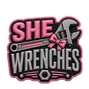 May include: A graphic design featuring the words "SHE WRENCHES" in a 3D embroidered style. The design includes a wrench, a pink bow, and a nut and bolt, all set against a black and pink background.