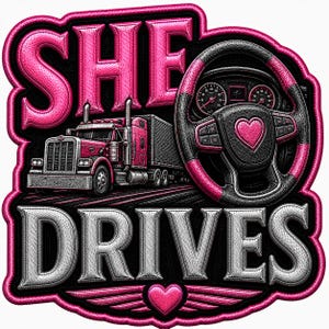 May include: A graphic design featuring the text SHE DRIVES in bold, embossed lettering. The image includes a pink semi-truck, a black and pink steering wheel with a heart emblem, and a small pink heart with wings at the bottom center.