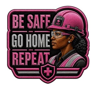 May include: A rectangular embroidered patch with rounded corners featuring a pink hard hat, safety glasses, and a high-visibility vest. The text reads BE SAFE GO HOME REPEAT with a shield icon containing a pink cross at the bottom center.