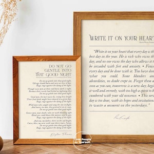 May include: Two framed prints with inspirational quotes. The print on the left is a poem by Dylan Thomas titled "Do Not Go Gentle Into That Good Night". The print on the right is a quote by Rabindranath Tagore titled "Write It On Your Heart".