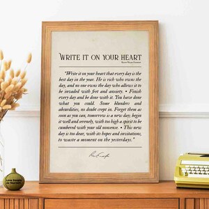 May include: A framed print with a beige background and a black text quote by Ralph Waldo Emerson that reads "Write it on your heart that every day is the best day in the year. He is rich who owns the day, and no one owns the day who allows it to be invaded with fret and anxiety. Finish every day and be done with it. You have done what you could. Some blunders and absurdities, no doubt crept in. Forget them as soon as you can, tomorrow is a new day; begin it well and serenely, with too high a spirit to be cumbered with your old nonsense. This new day is too dear, with its hopes and invitations, to waste a moment on the yesterdays."