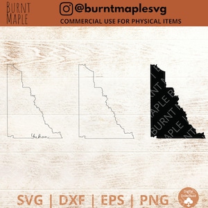 May include: Outline and solid black silhouette of the Yukon Territory, Canada. The outline is labelled "Yukon".