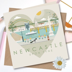 May include: A heart-shaped illustration of the Newcastle upon Tyne skyline, featuring the Tyne Bridge, the Millennium Bridge, and a river. The illustration is in a vintage style with a green, yellow, and blue colour palette. The text "NEWCASTLE UPON TYNE" is written below the illustration.
