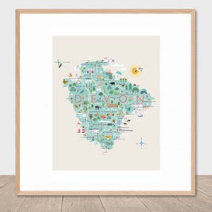 May include: A colourful illustrated map of Devon, England, with the word "Devon" in large letters at the top. The map shows various landmarks, towns, and cities throughout the county, including Plymouth, Exeter, and Dartmoor National Park.