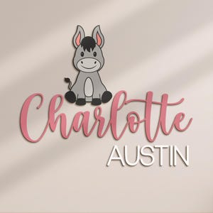 May include: A wooden wall decoration featuring a cartoon donkey above the name "Charlotte" in pink script, with "AUSTIN" in white block letters below. The donkey is gray with black and pink accents.
