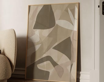 May include: Abstract art print in a wooden frame. The artwork features overlapping shapes in shades of beige, brown, and white. The text "BY GABIS" is printed at the bottom. The print is leaning against a wall.