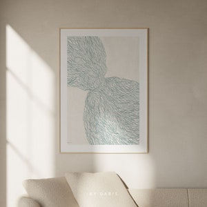 May include: A framed abstract art print with a light beige background and a teal blue design of overlapping organic shapes. The design resembles a network of lines and curves.
