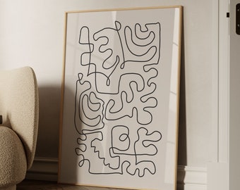 May include: A black and white abstract line art print with the text "BY GABIS" at the bottom. The print is framed in a light wood frame.