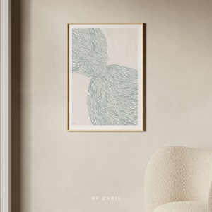 May include: Abstract art print with a light green design of overlapping organic shapes on a white background. The print is framed in a light wood frame.