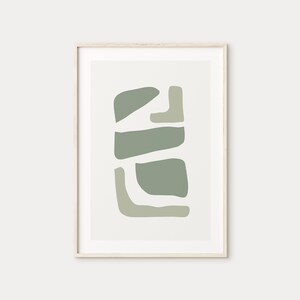 May include: Abstract art print with a geometric design in shades of green. The print is framed in a light wood frame.