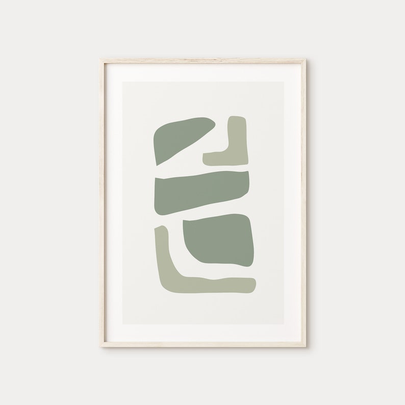 May include: Abstract art print with a geometric design in shades of green. The print is framed in a light wood frame.