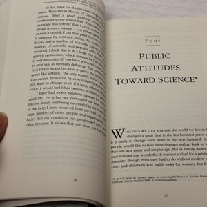 May include: A book cover with the title "Public Attitudes Toward Science" in black text on a white background. The book cover is open to a page with text about the changes in the world over the last hundred years.