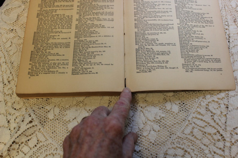 May include: An open book with yellowed pages and black text. The book is open to a page with the word "Physicians" at the bottom of the page.