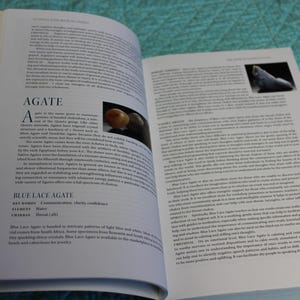 May include: Open book with pages displaying text and images. The left page features the title "AGATE" and text describing the gemstone. The right page has more text and a small image of a stone.