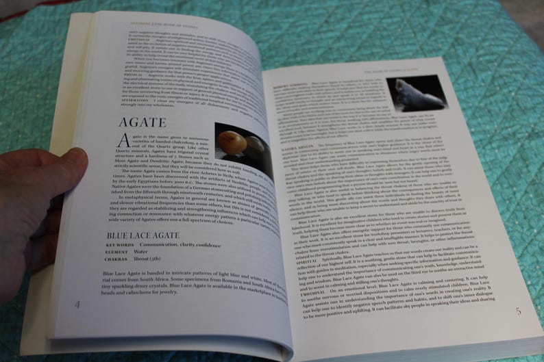 May include: Open book with pages displaying text and images. The left page features the title "AGATE" and text describing the gemstone. The right page has more text and a small image of a stone.