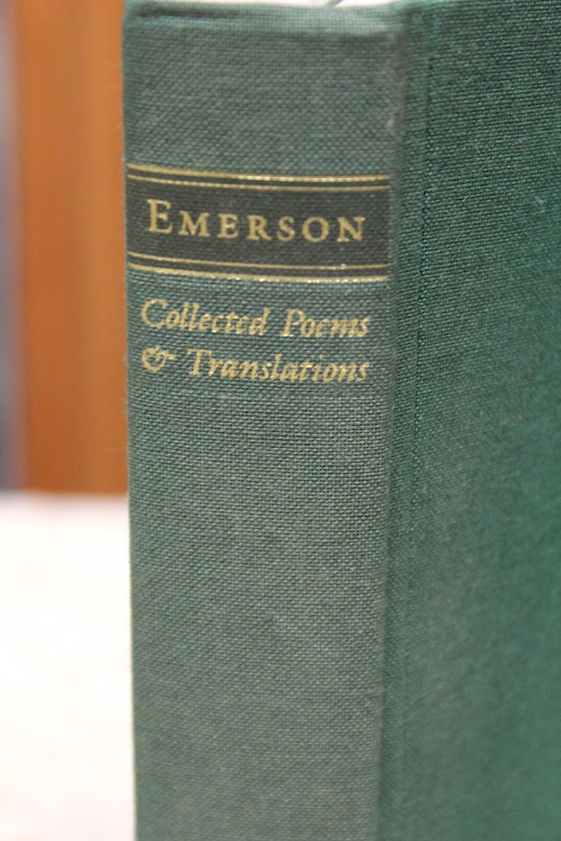May include: A green hardcover book with gold lettering on the spine. The title is "EMERSON Collected Poems & Translations".