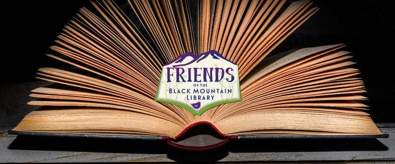 May include: An open book with aged, yellowed pages, fanned out to display the text. A logo reading "FRIENDS of the BLACK MOUNTAIN LIBRARY" is centered on the pages. The logo features a purple mountain range and green accents.