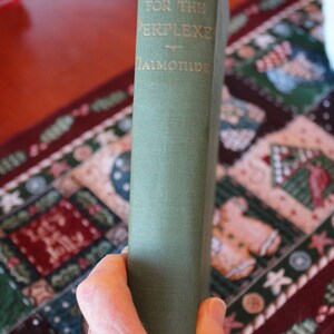 May include: A green hardcover book with the title "The Guide for the Perplexed" by E.F.  Benson.