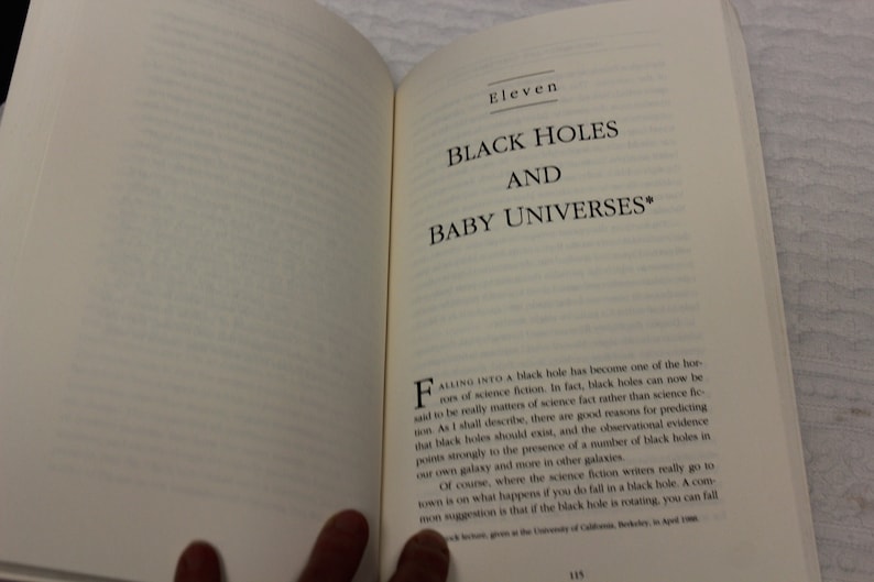 May include: A book titled "Black Holes and Baby Universes" with the text "Falling into a black hole has become one of the horrors of science fiction. In fact, black holes can now be said to be really matters of science fact rather than science fiction."