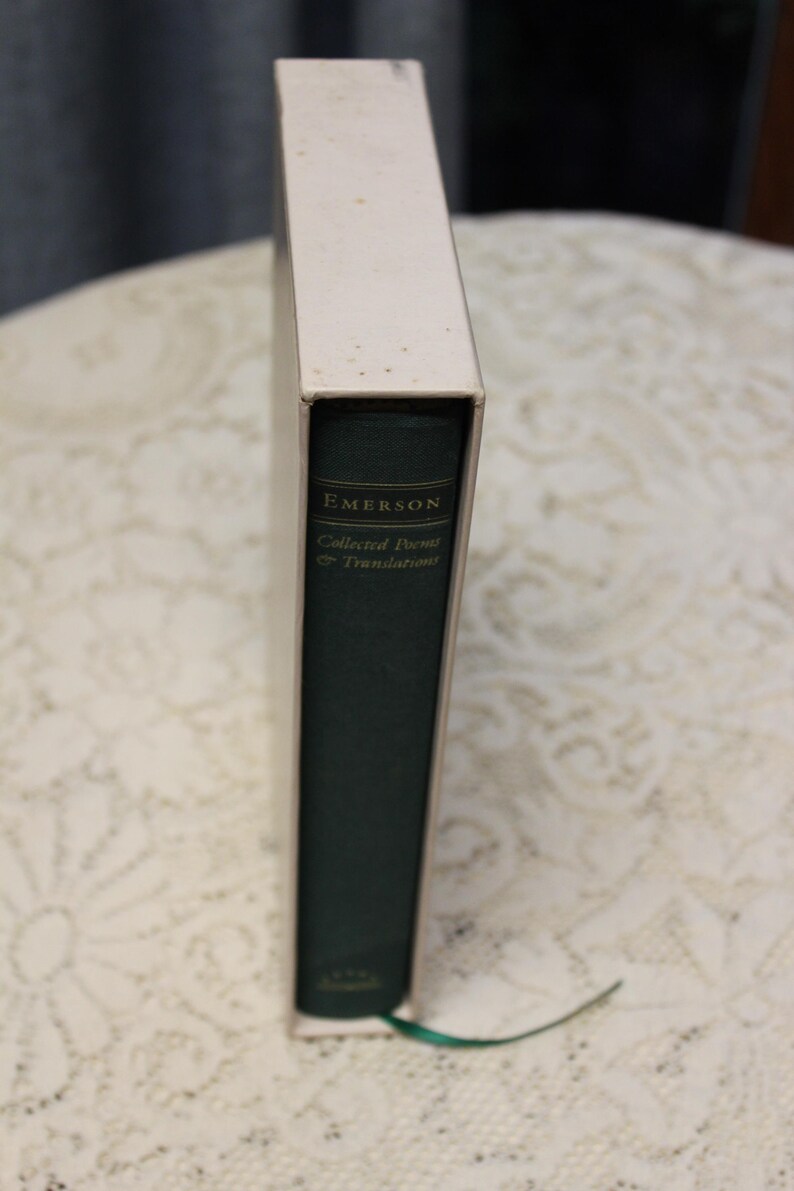 May include: A green hardcover book with the title "EMERSON Collected Poems & Translations" on the spine.