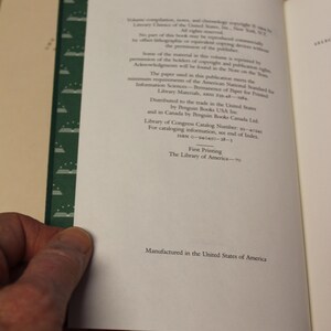 May include: A close-up of the copyright and publishing information page of a book. The page is white with black text. The text includes the title "Permanence of Paper for Printed Library Materials, ANSI Z39.48-1994."
