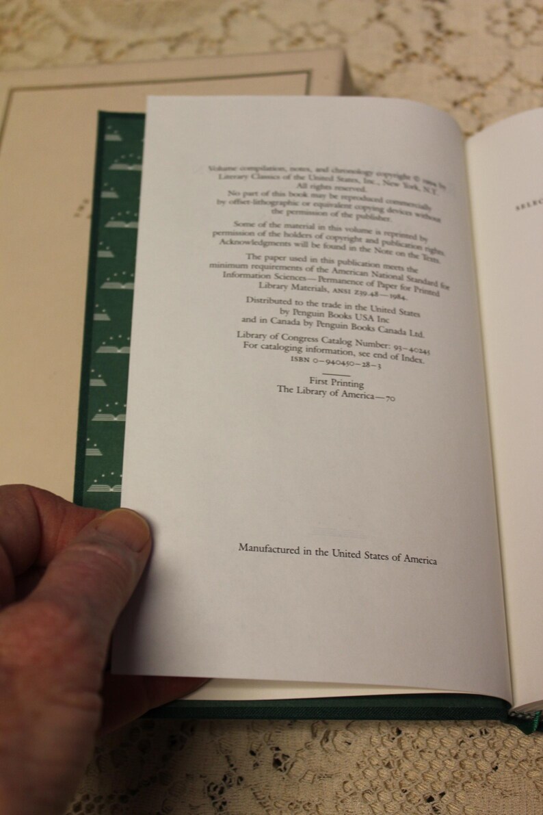 May include: A close-up of the copyright and publishing information page of a book. The page is white with black text. The text includes the title "Permanence of Paper for Printed Library Materials, ANSI Z39.48-1994."