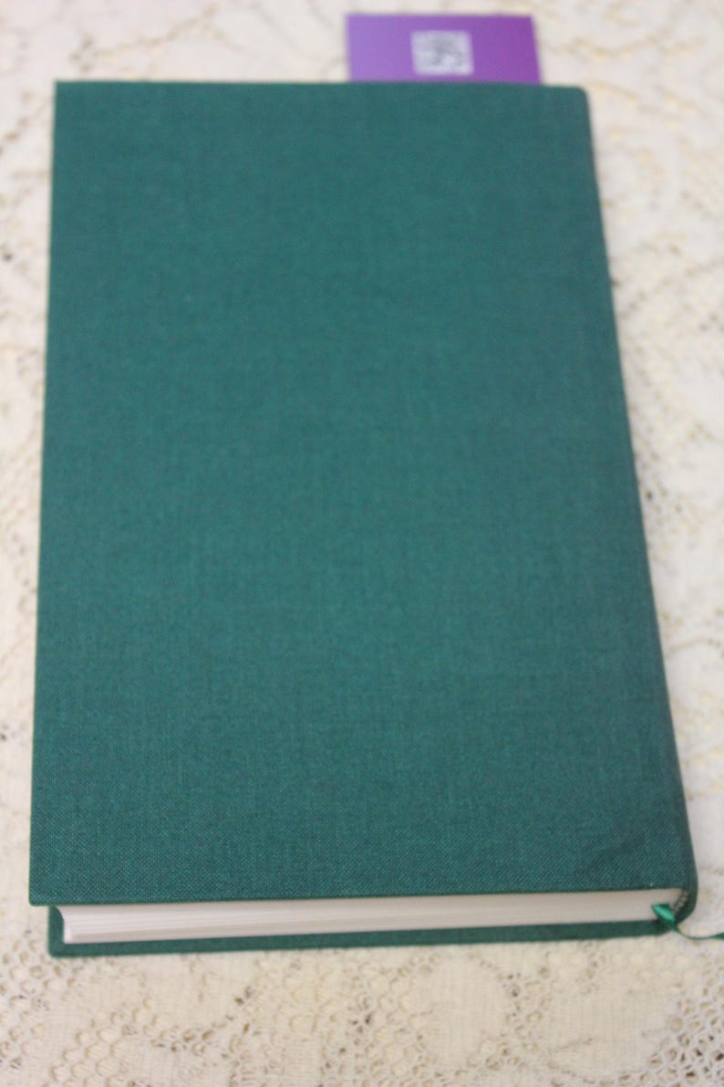 May include: A dark green hardcover book with a white spine.