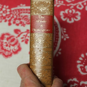 May include: A brown book with gold lettering on the spine. The title is "The Works of Shakespeare".