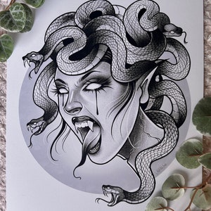 May include: Black and white illustration of Medusa, a mythical Greek creature with snakes for hair, a fierce expression, and fangs. The image is drawn in a detailed style with shading and texture.