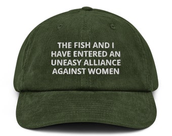 May include: A green corduroy baseball cap with white embroidered text that reads "The fish and I have entered an uneasy alliance against women."