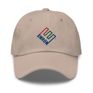 Op de afbeelding: Een beige baseballpet met een geborduurd logo met een blauw, rood en groen geometrisch ontwerp en het woord "ENRON" in blauw.