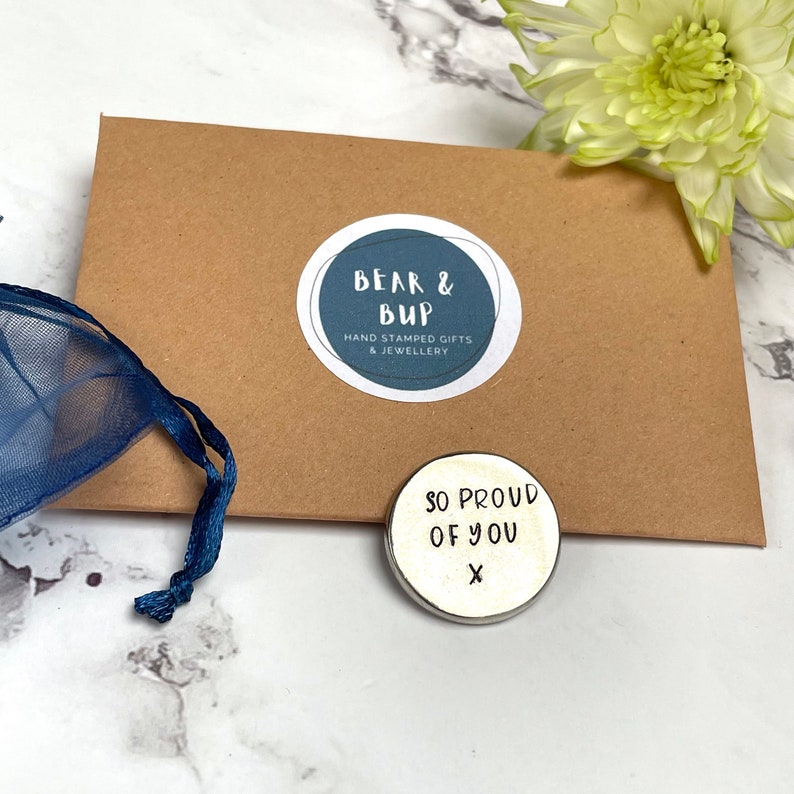 Good luck pocket token with so proud of you stamped on it.
