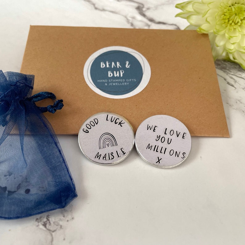 good luck aluminium pocket token with the name Maisie and a rainbow stamped on it.
The back of the token says we love you millions