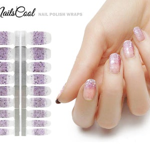 May include: Nail polish wraps with a white base and a gradient of purple glitter. The wraps are shown on a hand with a white background. The text "NailsCool" and "NAIL POLISH WRAPS" is visible in the image.