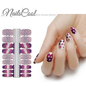 May include: Nail polish wraps with a gradient of purple, pink, and white with silver glitter polka dots. The wraps are shown on a model's fingernails.