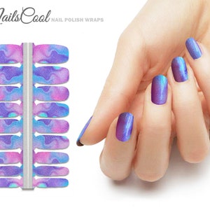 May include: Nail polish wraps with a swirling design in shades of purple, blue, and pink. The image also shows a hand with nails painted in a similar iridescent purple and blue color. The text "Nails Cool" and "Nail Polish Wraps" is visible.