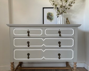 NOW SOLD!…..An elegant antique solid oak chest of drawers painted in a warm grey, white beading, brass hardware