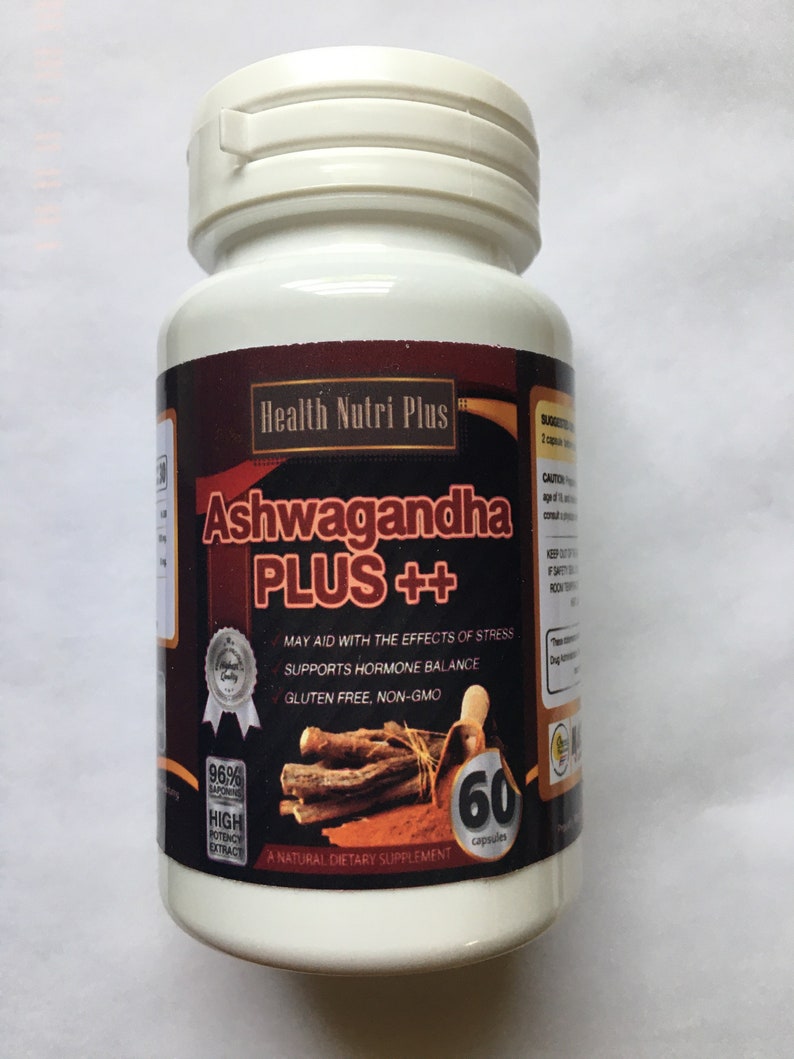 May include: A white bottle with a brown label that says "Health Nutri Plus Ashwagandha PLUS++". The label also says "May aid with the effects of stress, Supports hormone balance, Gluten free, Non-GMO". The bottle contains 60 capsules and is a natural dietary supplement.