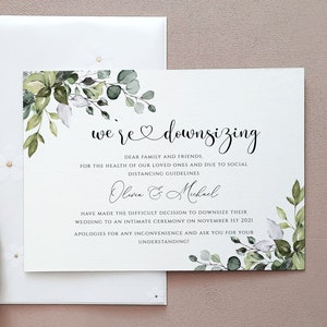 May include: A wedding announcement card with the text "we're downsizing" and floral decorations. The invitation includes the names Olivia & Michael and details about an intimate ceremony. A decorative fan and envelope with a wax seal are also visible.