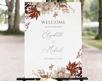 May include: A white wedding welcome sign with fall-themed floral illustrations. The sign reads "Welcome to our wedding Elizabeth & Michael October 21, 2023".