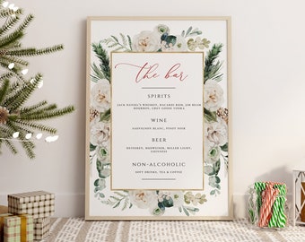 May include: A printable sign for a bar at a holiday party. The sign has a white background with green and white floral illustrations. The text on the sign reads "The Bar" in red cursive font. The sign lists the drinks available at the bar, including spirits, wine, beer, and non-alcoholic options.