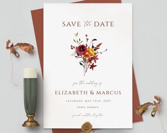 May include: Save the Date wedding announcement with a watercolor floral bouquet in shades of red, orange, and yellow. The announcement includes the names Elizabeth & Marcus, the date Saturday, May 15th, 2023, and the location Paris, France.