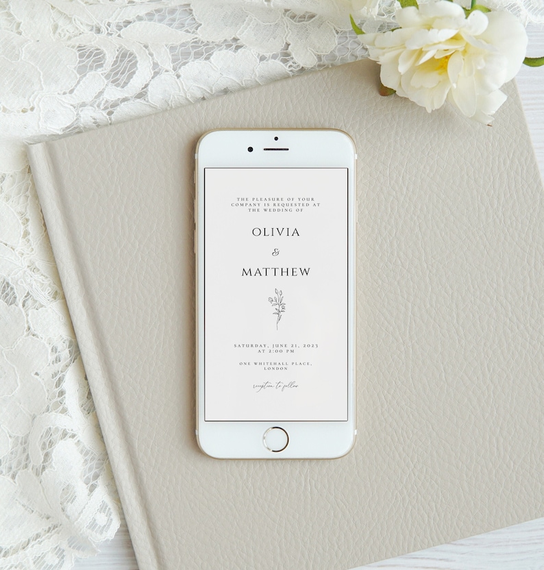 May include: A digital wedding invitation on a smartphone screen. The invitation is for the wedding of Olivia and Matthew, taking place on Saturday, June 21, 2023 at 2:00 PM at One Whitehall Place, London.
