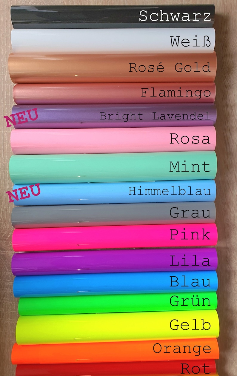 Pode incluir: Uma variedade de folhas de vinil em diferentes cores, incluindo preto, branco, ouro rosa, flamingo, lavanda brilhante, rosa, menta, azul celeste, cinza, rosa, roxo, azul, verde, amarelo, laranja e vermelho. As folhas s&atilde;o etiquetadas com os nomes alem&atilde;es de cada cor.