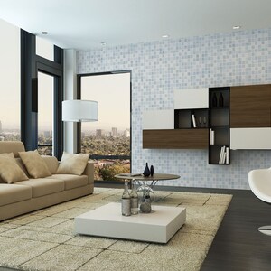 May include: A modern living room with a beige sofa, a white coffee table, and a white and black egg chair. The room has large windows with a view of a city skyline. The wall is covered in blue and white mosaic tiles.