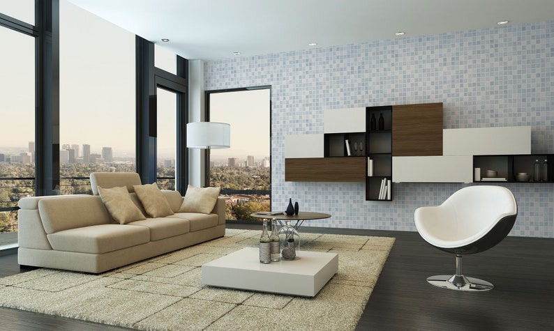 May include: A modern living room with a beige sofa, a white coffee table, and a white and black egg chair. The room has large windows with a view of a city skyline. The wall is covered in blue and white mosaic tiles.