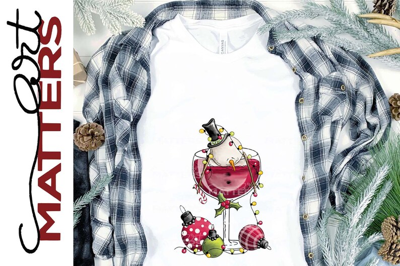 May include: A white snowman wearing a black top hat is submerged in a glass of red wine. The snowman is decorated with a string of white lights. Three Christmas ornaments are scattered around the base of the glass.