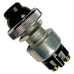 May include: A chrome-plated push button switch with a black rubber button. The switch has three terminals for wiring.